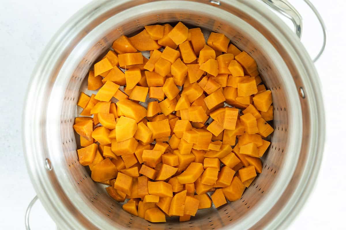 Cubed sweet potatoes in a pot.
