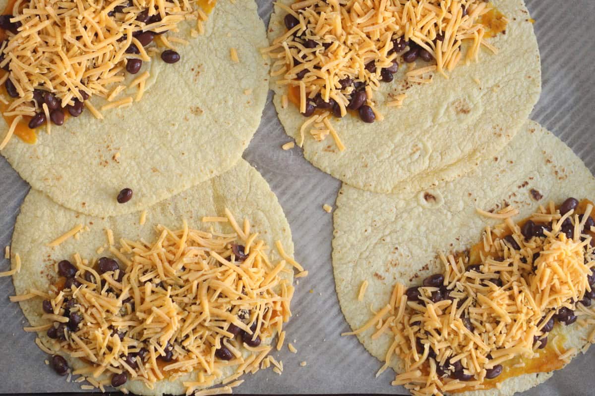 Black bean quesadillas with beans and cheese on tortillas.