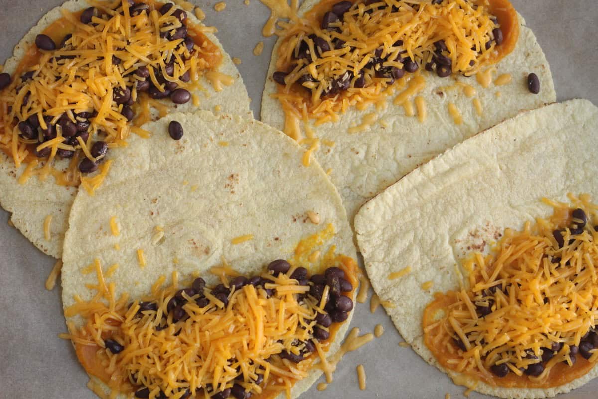 Black bean quesadillas with beans and cheese on tortillas.