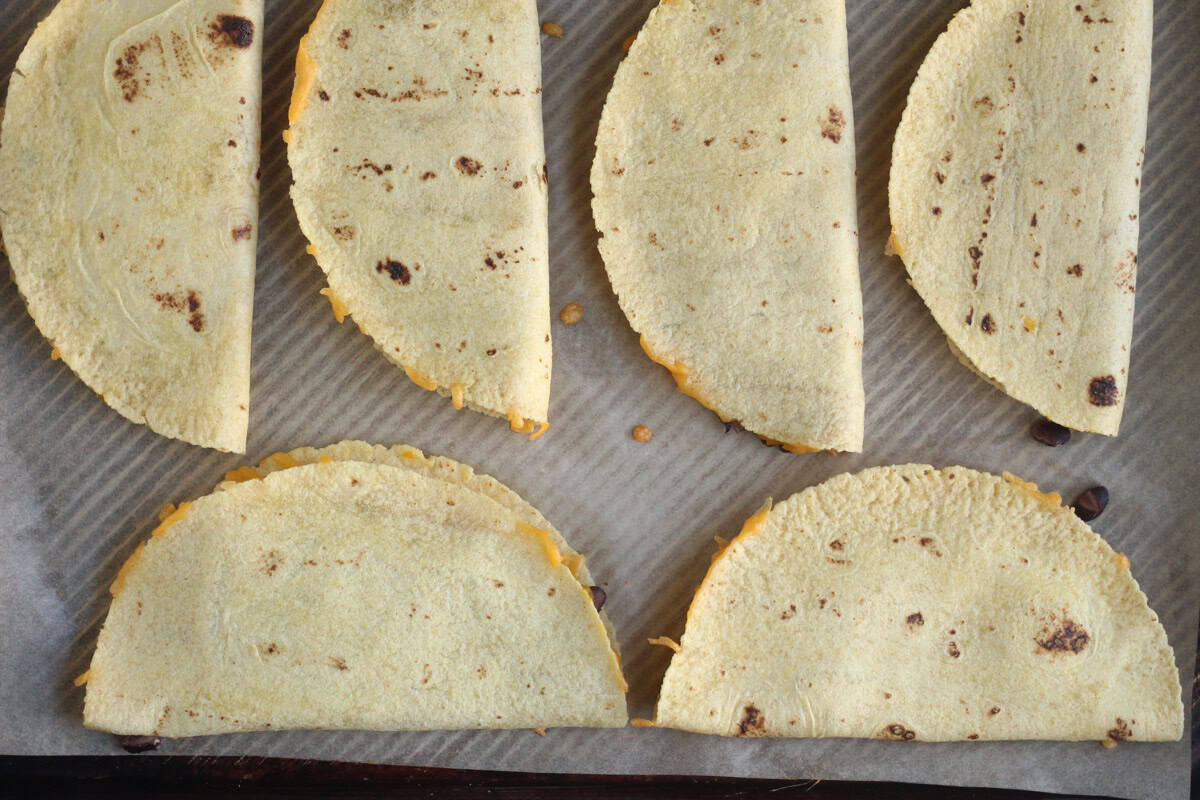 Baked black bean quesadillas on a baking sheet.