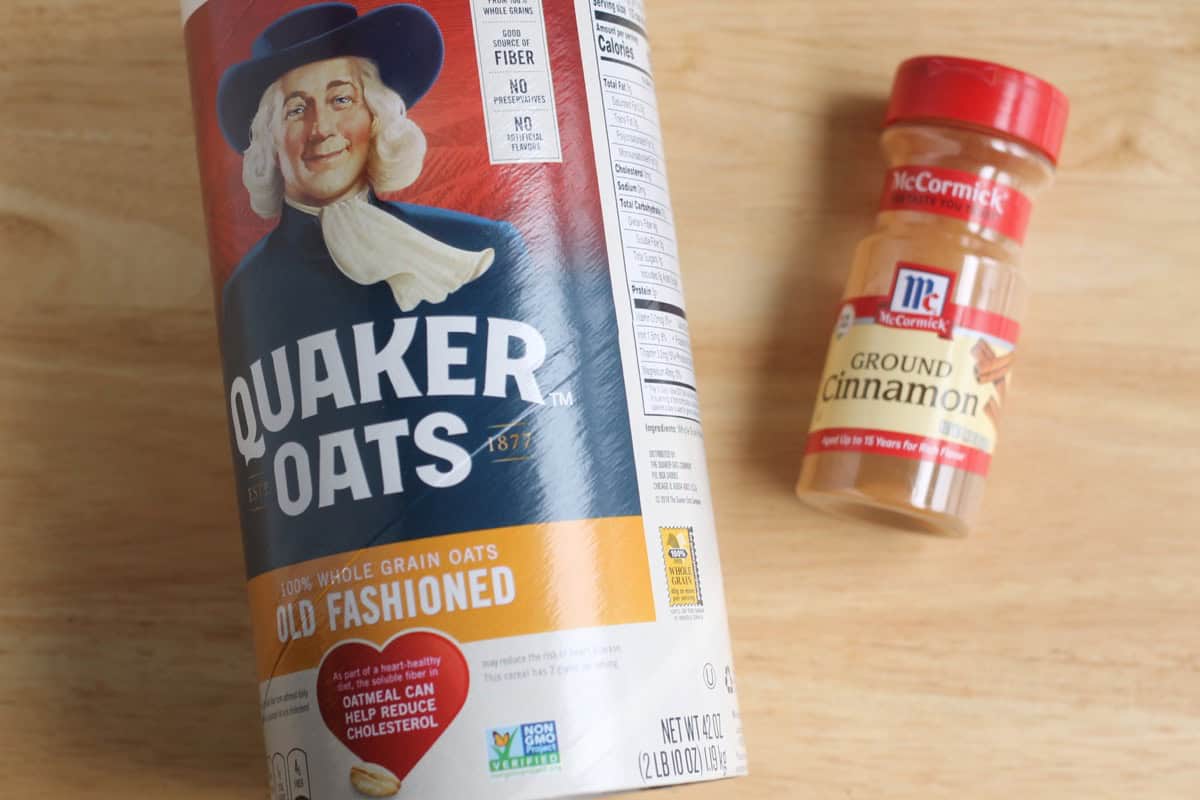 Oats and ground cinnamon on a cutting board.