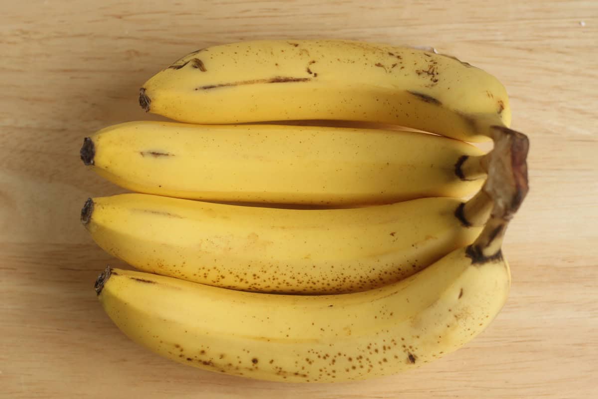 Ripe bananas on a cutting board.