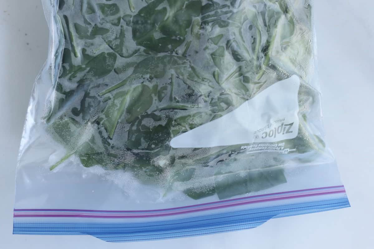 Frozen spinach in a sealed freezer bag.