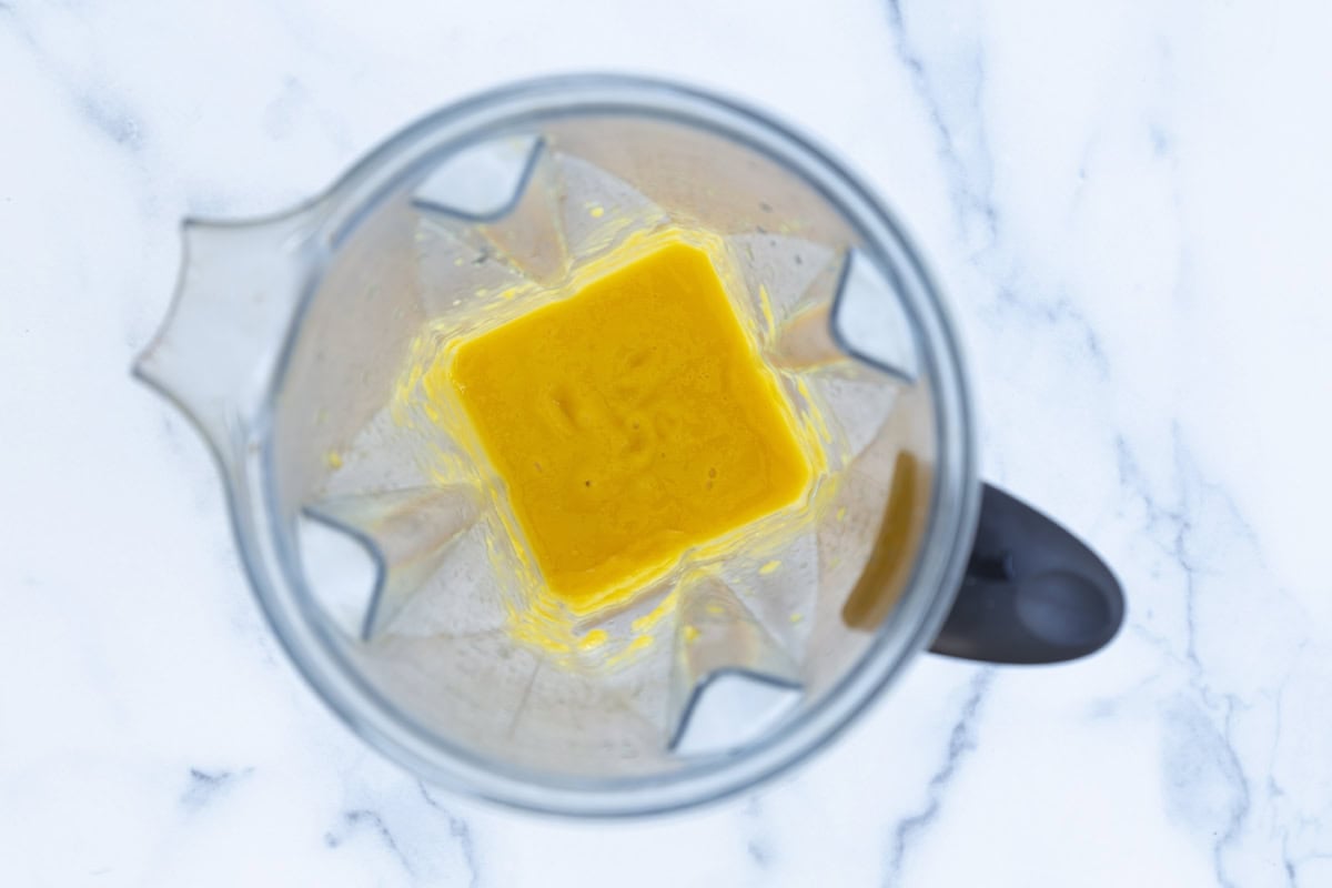 Pureed mango in a blender.