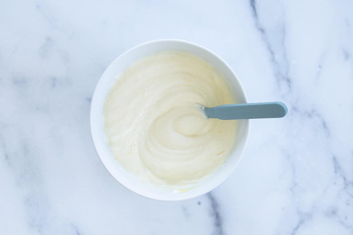 Smooth mango yogurt in a bowl.