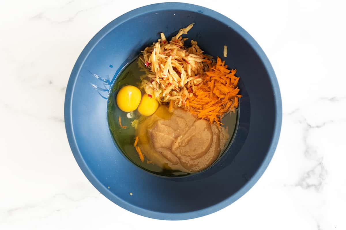 Muffin ingredients in a blue mixing bowl.