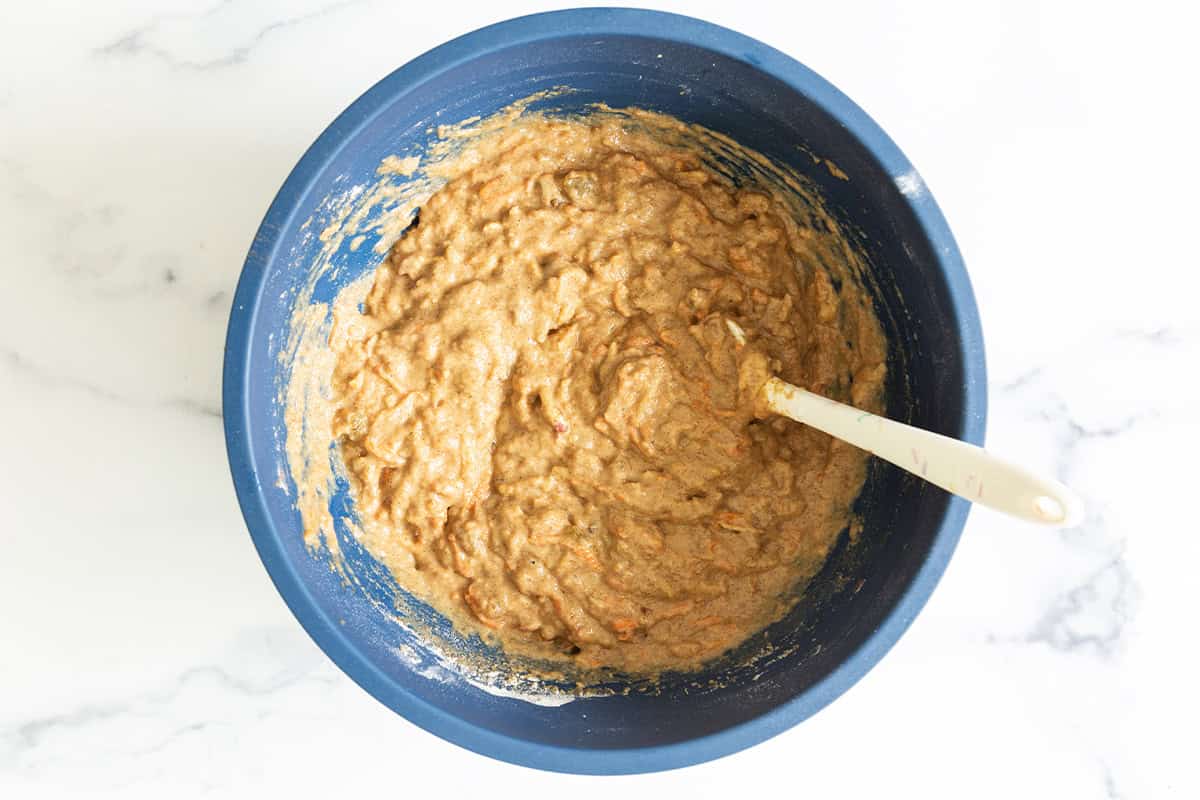 Morning glory muffin batter in a blue bowl.
