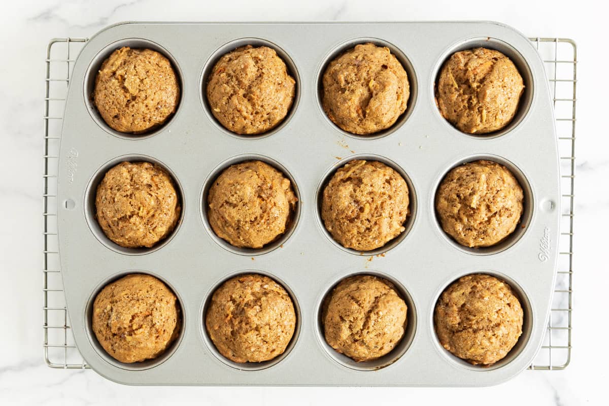 Baked morning glory muffins in a muffin pan.