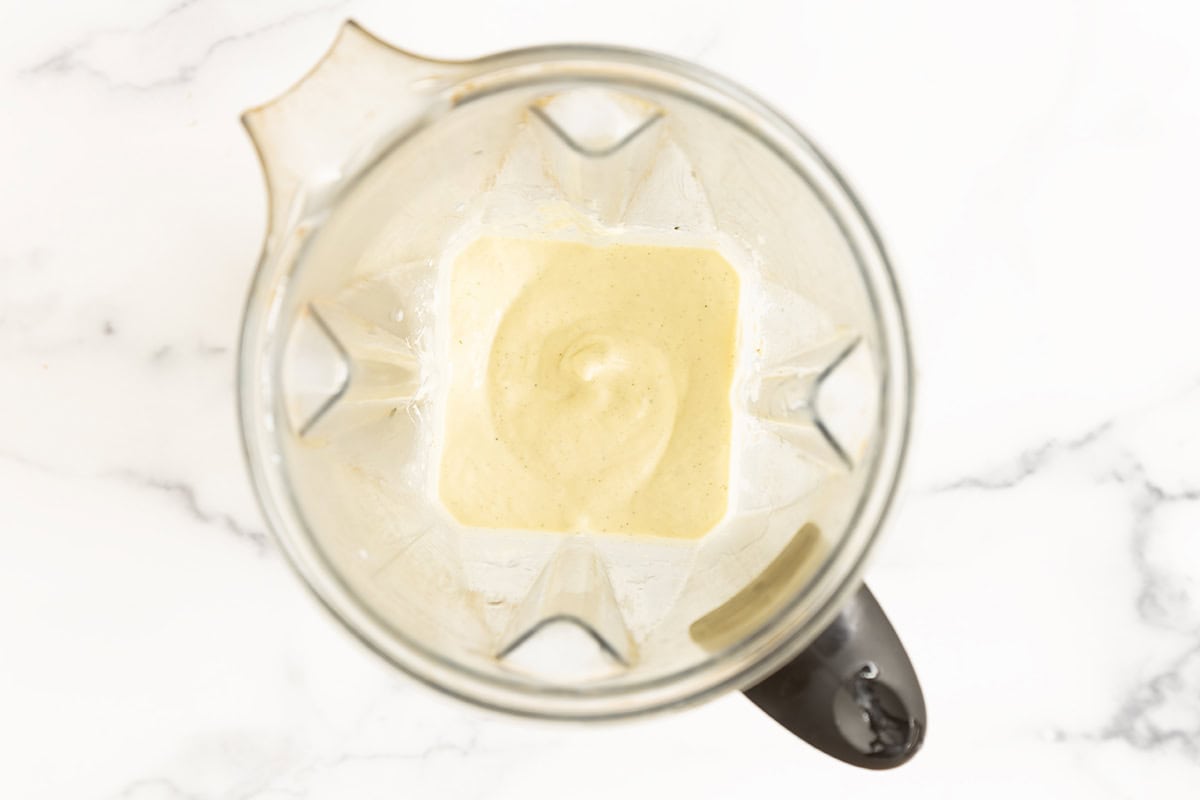 Blended pineapple smoothie in a blender.
