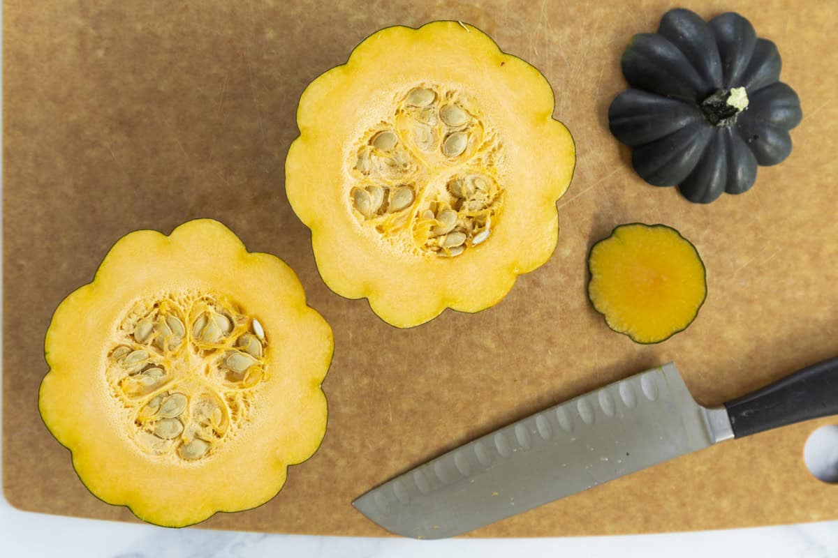 Acorn squash cut in half with seeds inside.