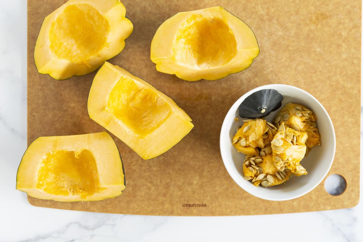 Acorn squash halves with seeds scooped out.