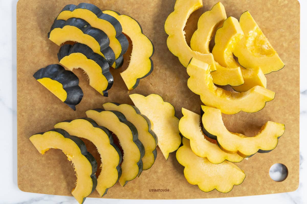 Sliced acorn squash on a cutting board.