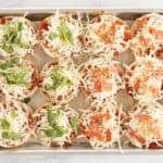 bagel pizza bites on baking sheet.
