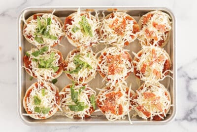 bagel pizza bites on baking sheet.