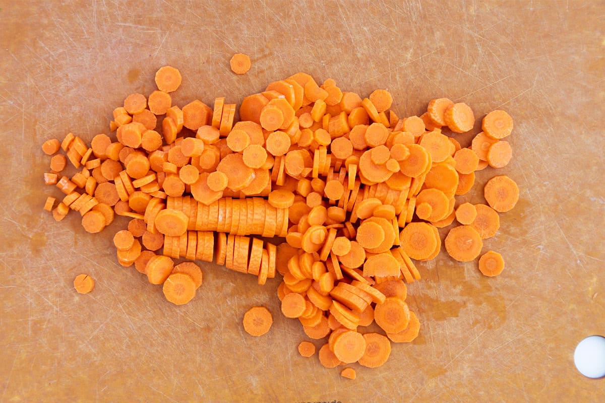 Sliced carrot rounds on a cutting board.