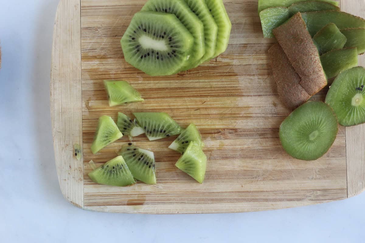 Diced kiwi on a cutting board.