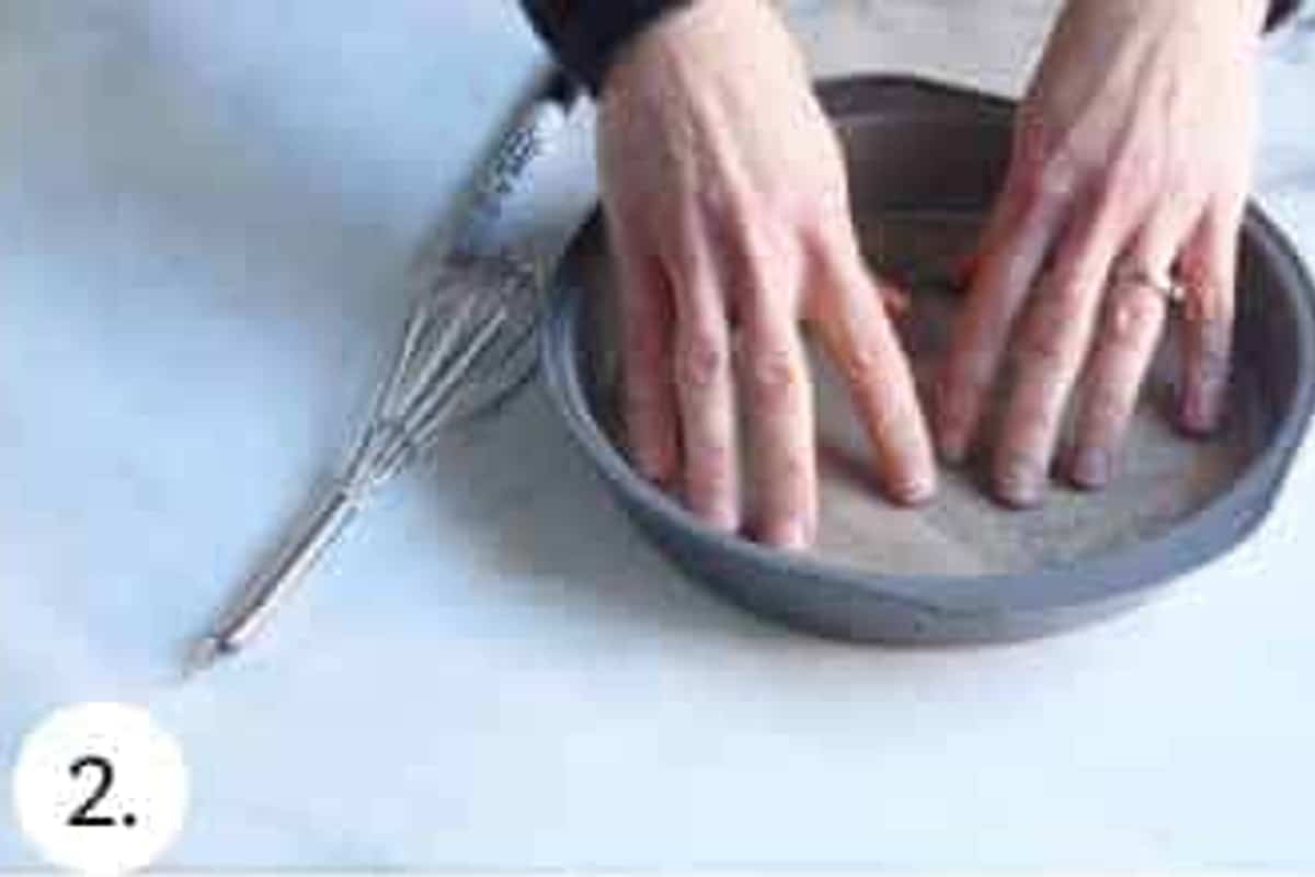Parchment paper pressed into a greased round cake pan.