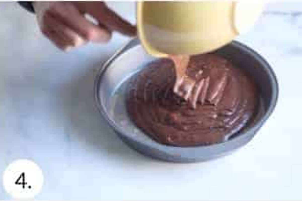 Chocolate cake batter poured into a round cake pan.