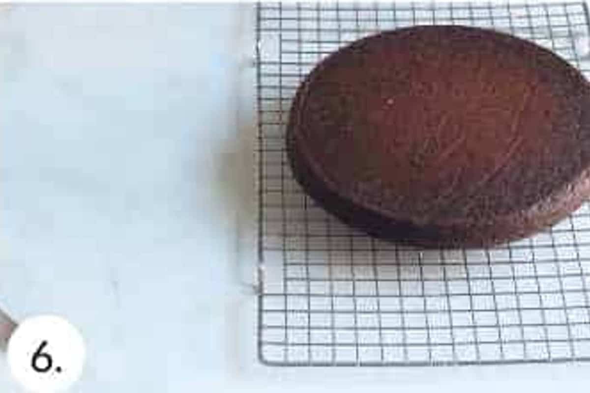 Chocolate cake cooling on a wire rack.