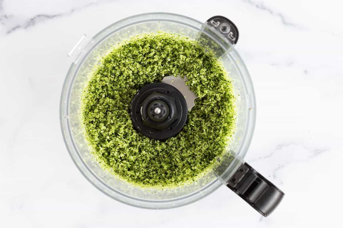 Chopped broccoli in a food processor.