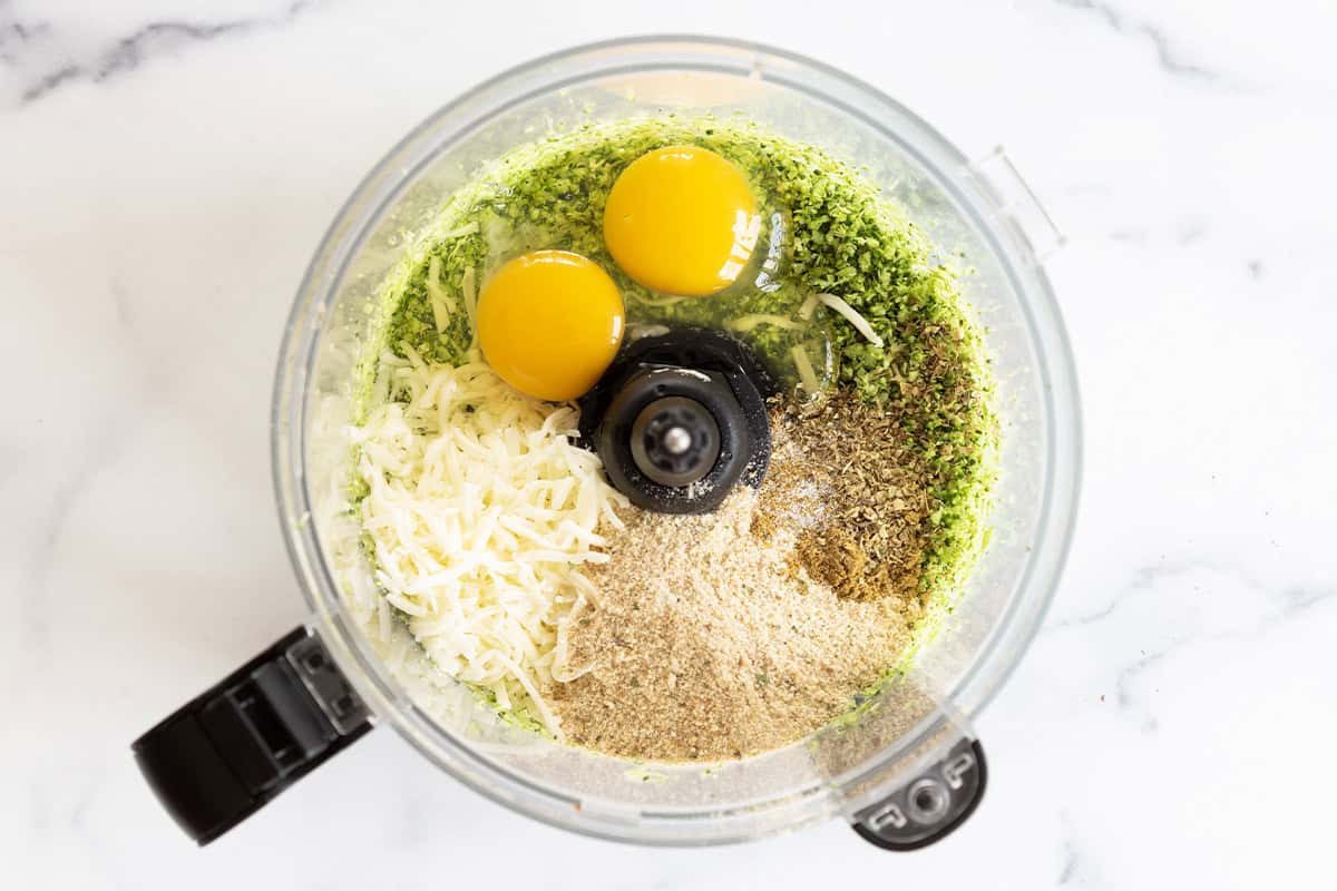 Broccoli fritter ingredients in a food processor.