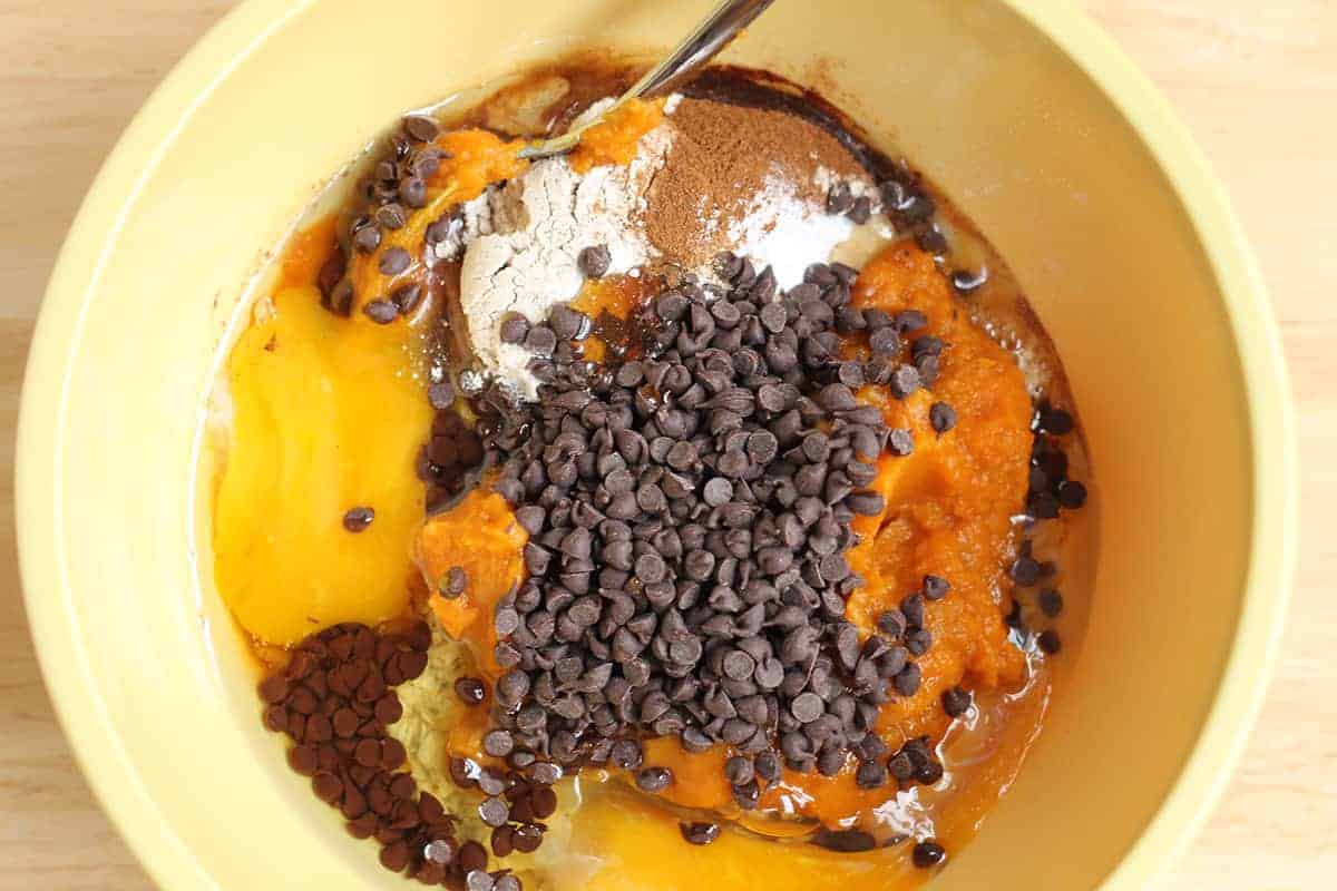 Pumpkin bar ingredients in a yellow mixing bowl.