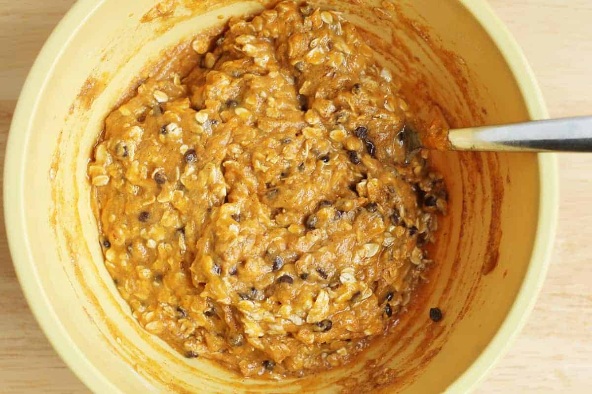 Pumpkin bar batter stirred in a yellow mixing bowl.