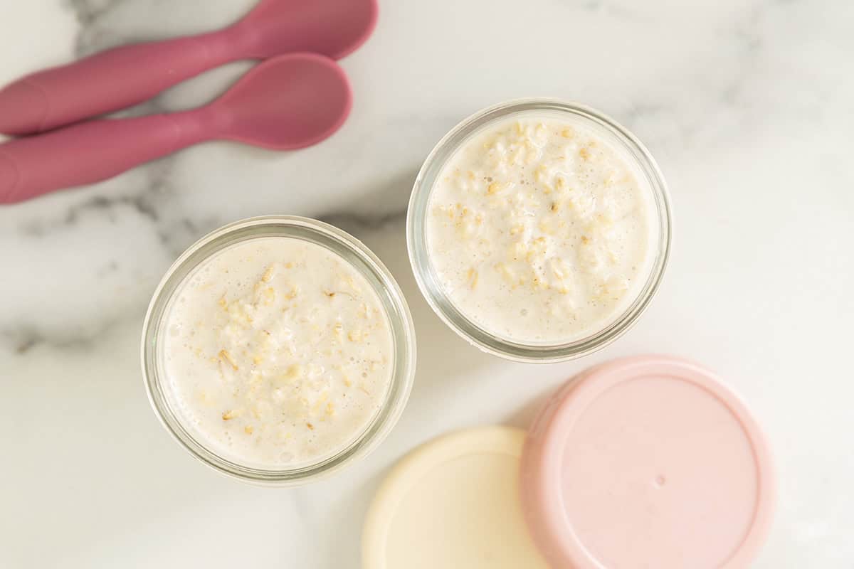 Banana overnight oats divided between two glass jars.