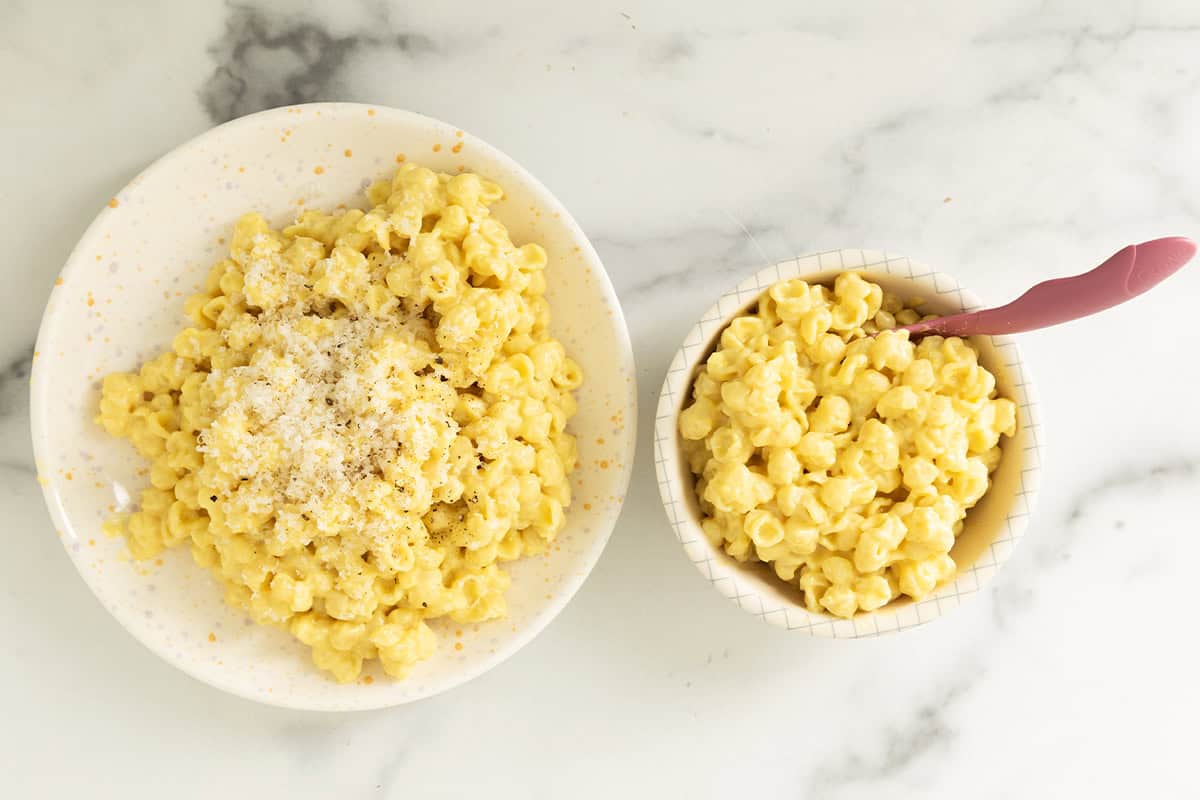 two bowls of butternut squash pasta on counter.