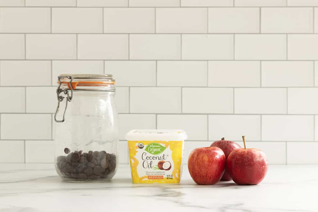 Dark chocolate chips, coconut oil, and apples for chocolate covered apple slices.
