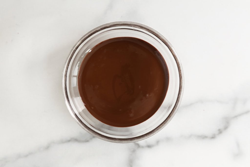 Melted chocolate and coconut oil in a glass bowl.