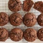 Chocolate pumpkin muffins on a cooling rack, including one split open.