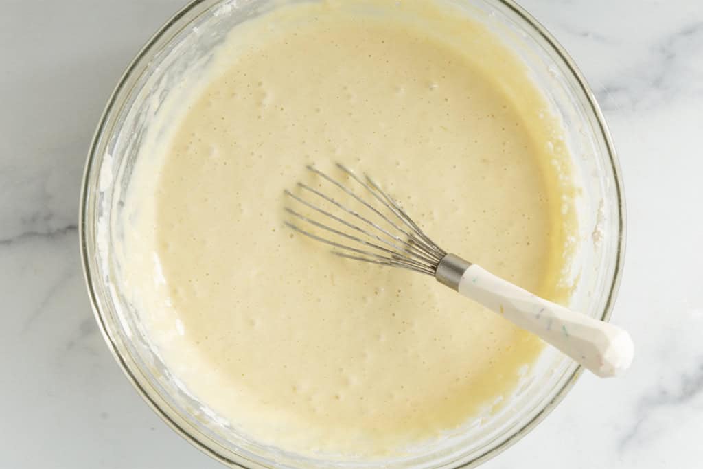 Batter for cinnamon swirl pancakes in glass bowl.