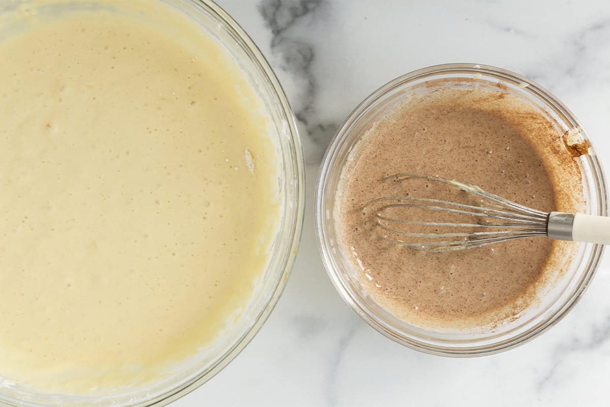 Cinnamon swirl mixture and pancake batter in two glass bowls.