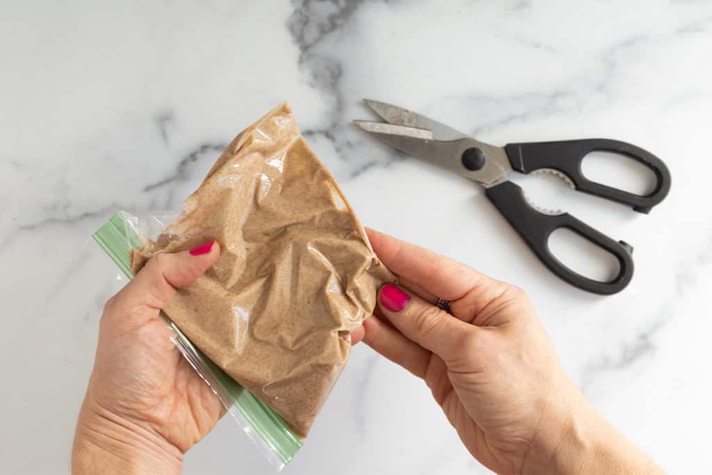 adding cinnamon swirl mixture to bag.