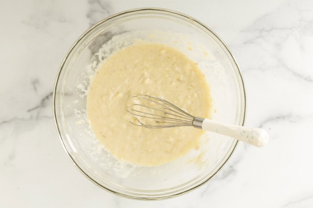 Wet ingredients in glass bowl for Eggless banana muffins.