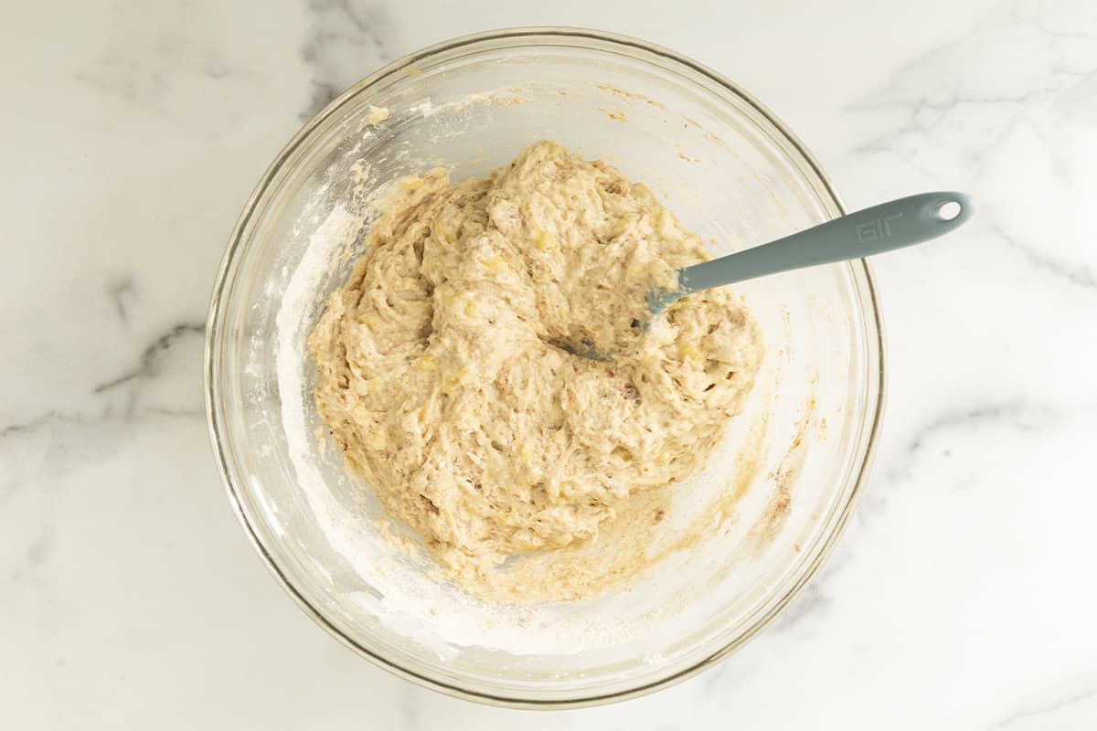 Batter for Eggless banana muffins in glass bowl.