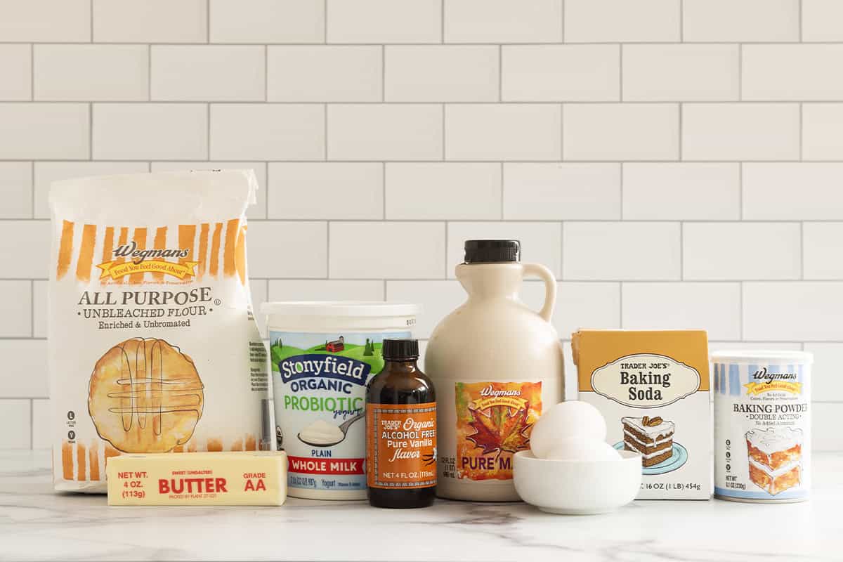 Flour, butter, yogurt, vanilla, maple syrup, eggs, baking soda, and baking powder for vanilla muffins.