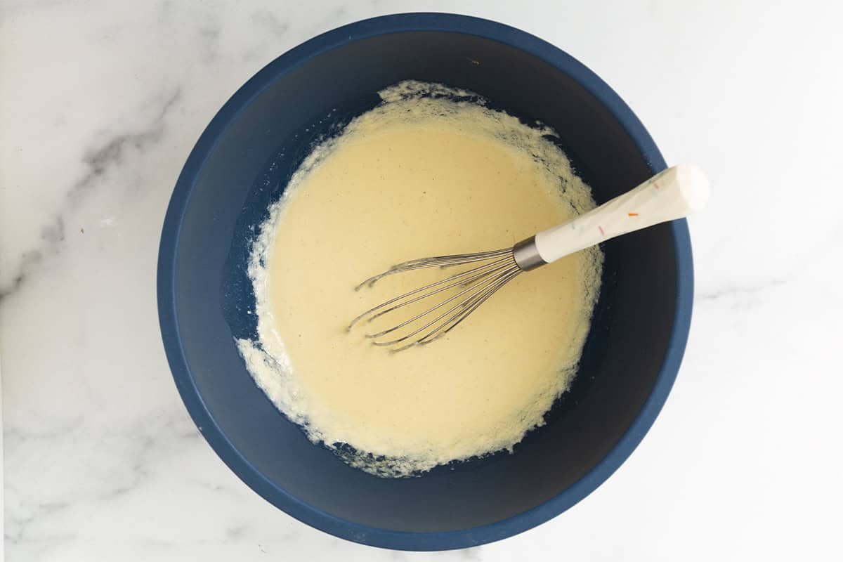 Wet ingredients whisked together in a blue mixing bowl.