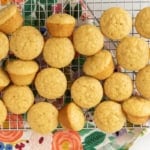 Mini vanilla muffins cooling on a wire rack.